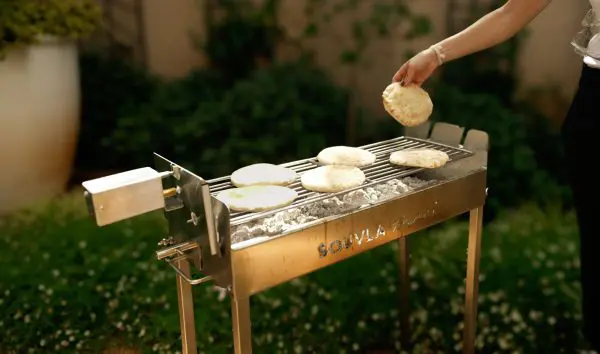 Pita being put on the souvla braai flat grill