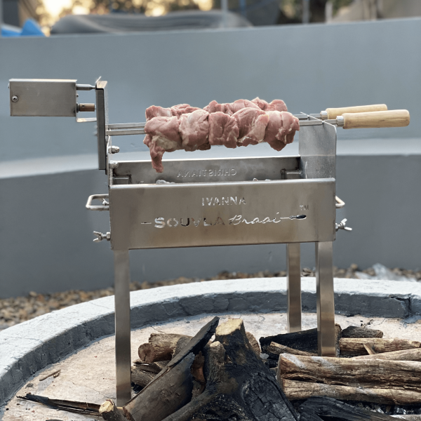 Delicious souvla being cooked on a ultra mini souvla braai in a fire pit