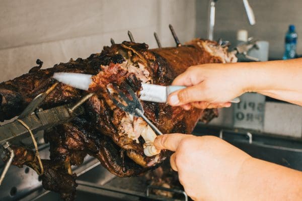 Lamb being cut up that was cooked on the spit pro souvla braai